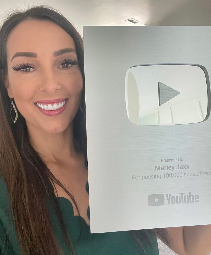 Marley Jaxx holding her YouTube Silver Play Button for 100,000 subscribers